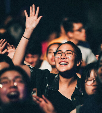 people raising hands in worship