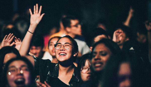 people raising hands in worship